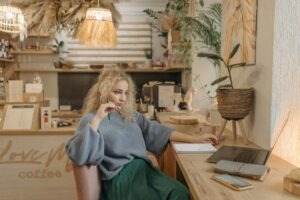 Solopreneur working on laptop in cozy cafe workspace using AI tools to automate tasks and boost productivity in Myrtle Beach South Carolina