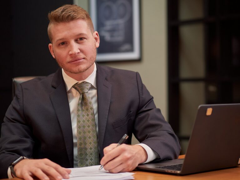 Attorney reviewing legal documents at a desk in a professional law office with natural light