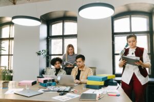 Pro-How AI helps small business teams automate routine work so they can focus on high-value collaboration &mdash; diverse team brainstorming with laptops in modern office